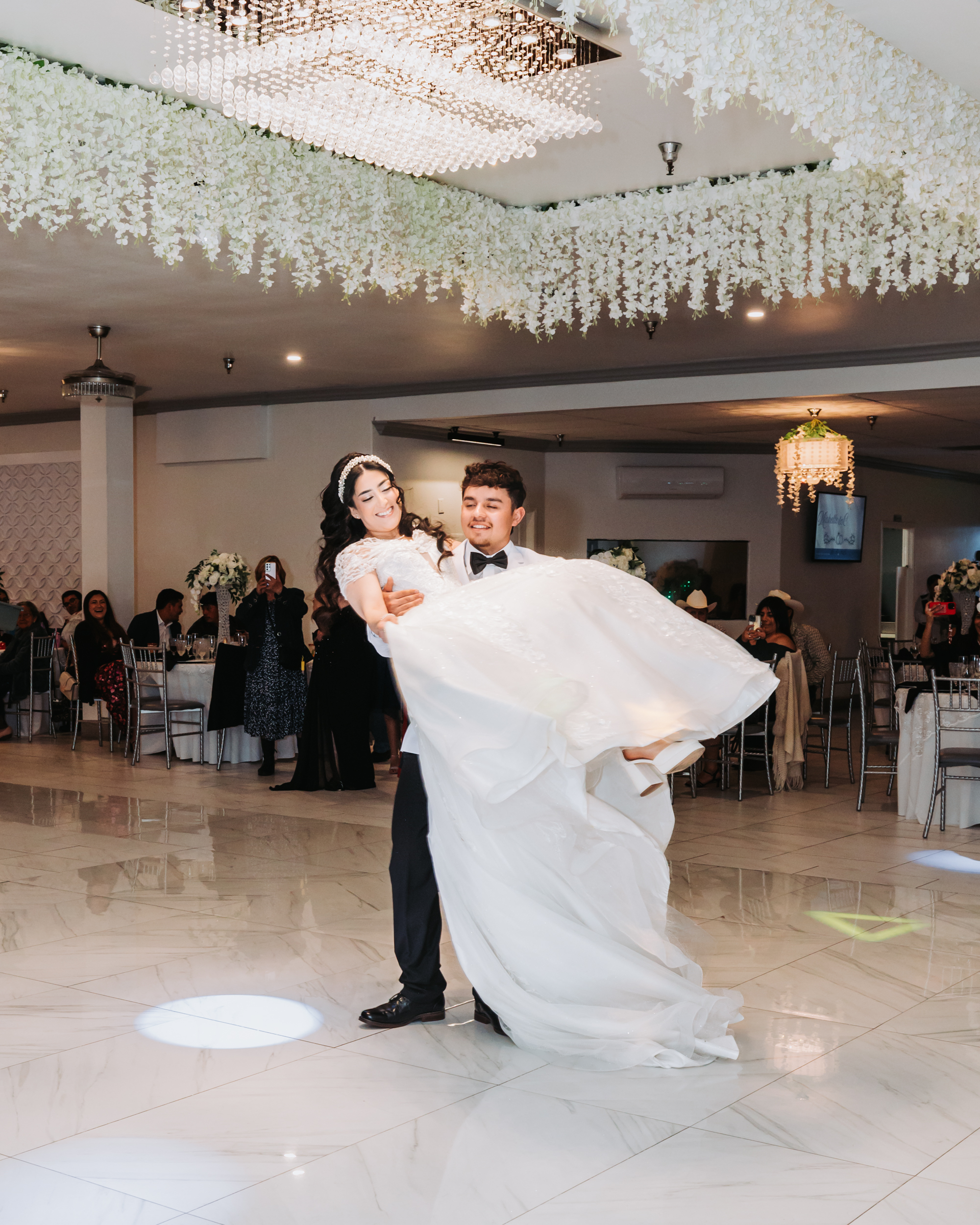 Groom carrying bride at Vive Banquet Hall